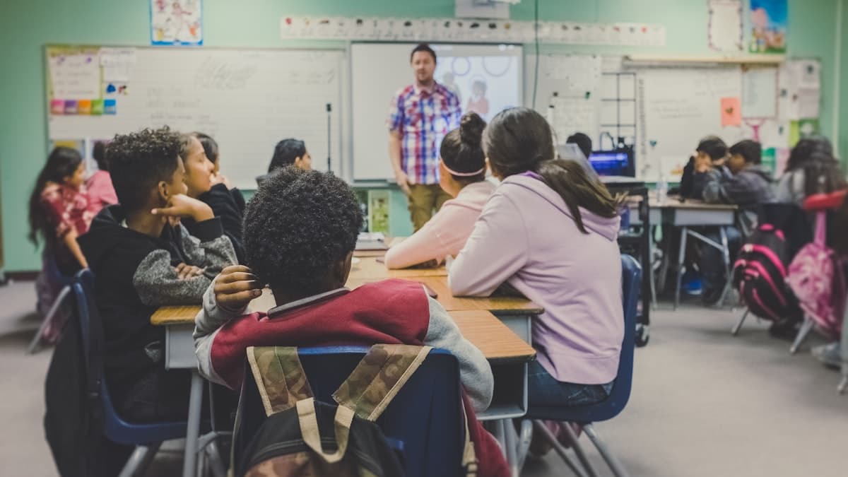 Students learning in a bright classroom, representing scholarship and educational opportunity